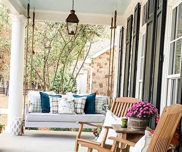 Hanging porch daybed with blue pillows